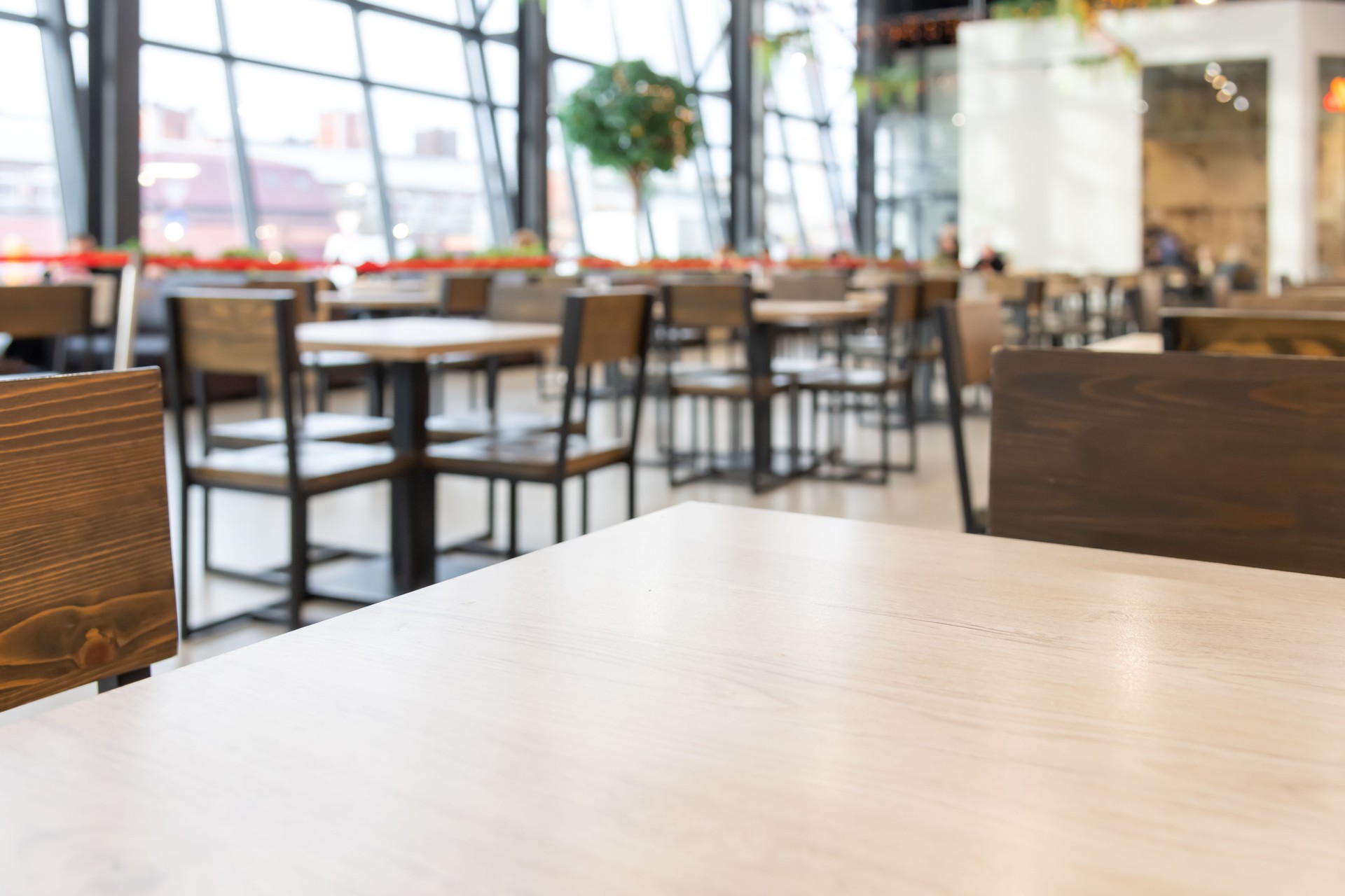 Empty wooden table in food court
